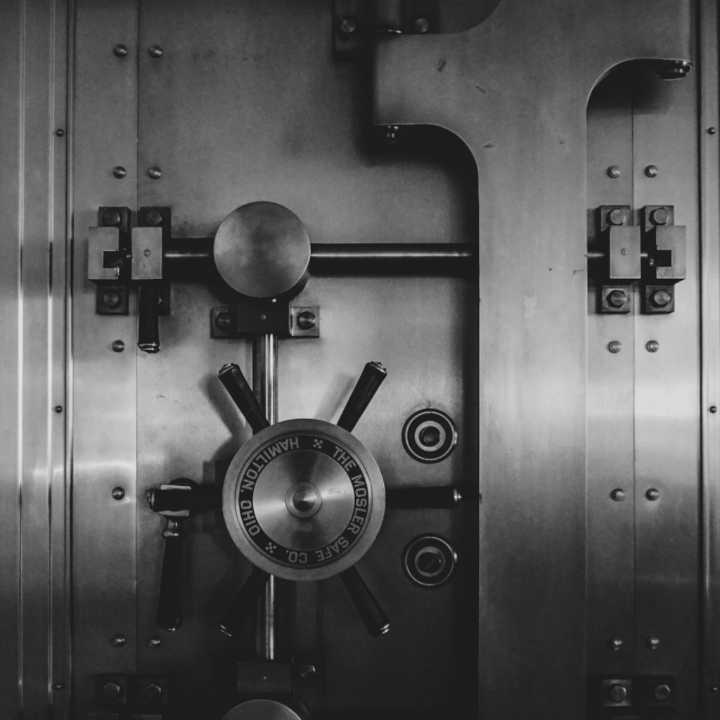 Heavy bank vault door, symbolizing asset security and protection