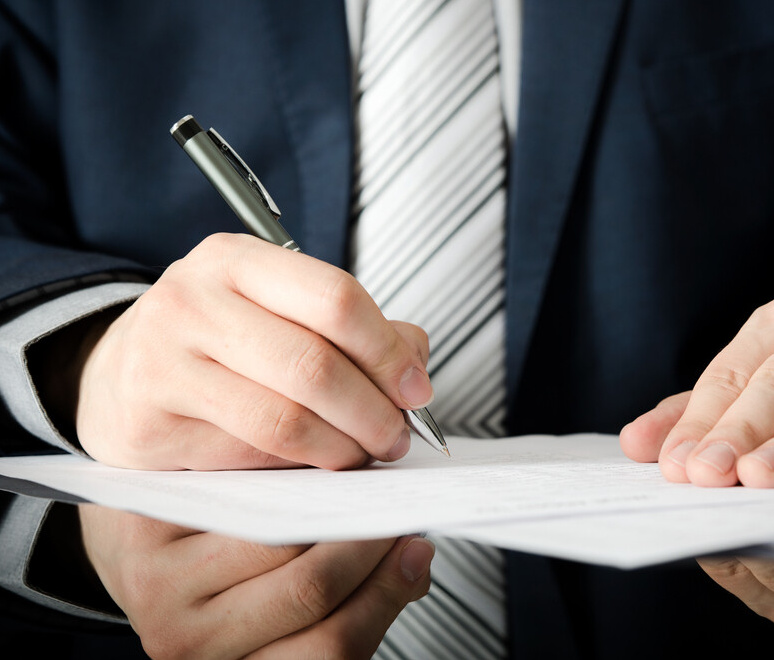 Aegis Griffin consultant taking notes in meeting, demonstrating professional diligence